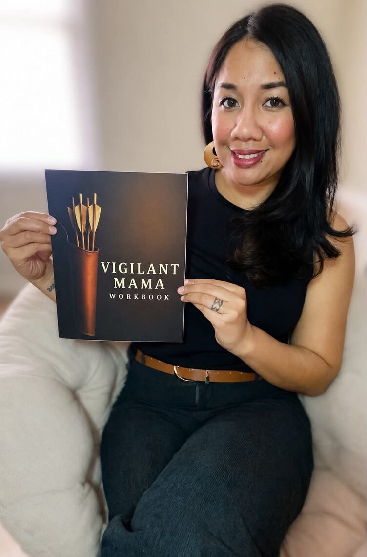 Rachel Ulu Vasquez, founder of Vigilant Mama, holding the Vigilant Mama Workbook