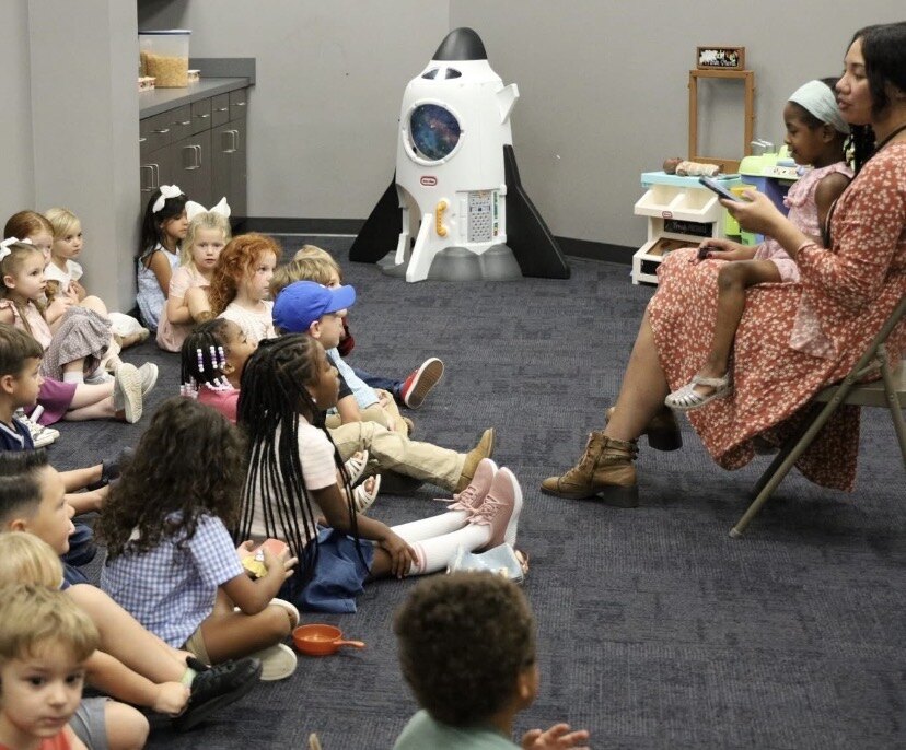 Rachel reading to a room full of children while serving in the children's ministry