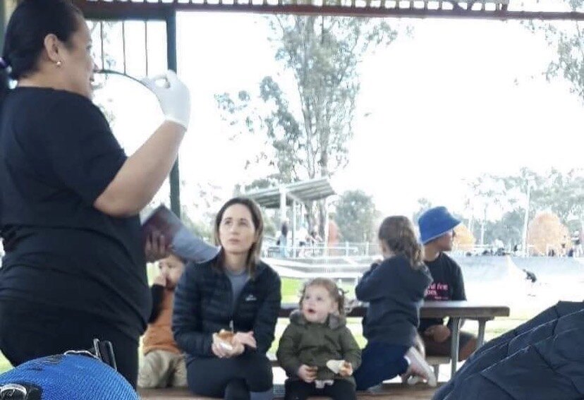 Women and children gathered at a park in Australia during a Gospel & Cookies outreach